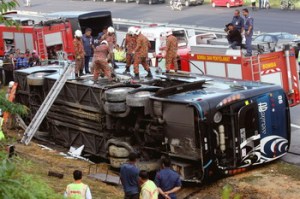 NST image of an express bus lying on its side after a crash that killed 6 people and injured more